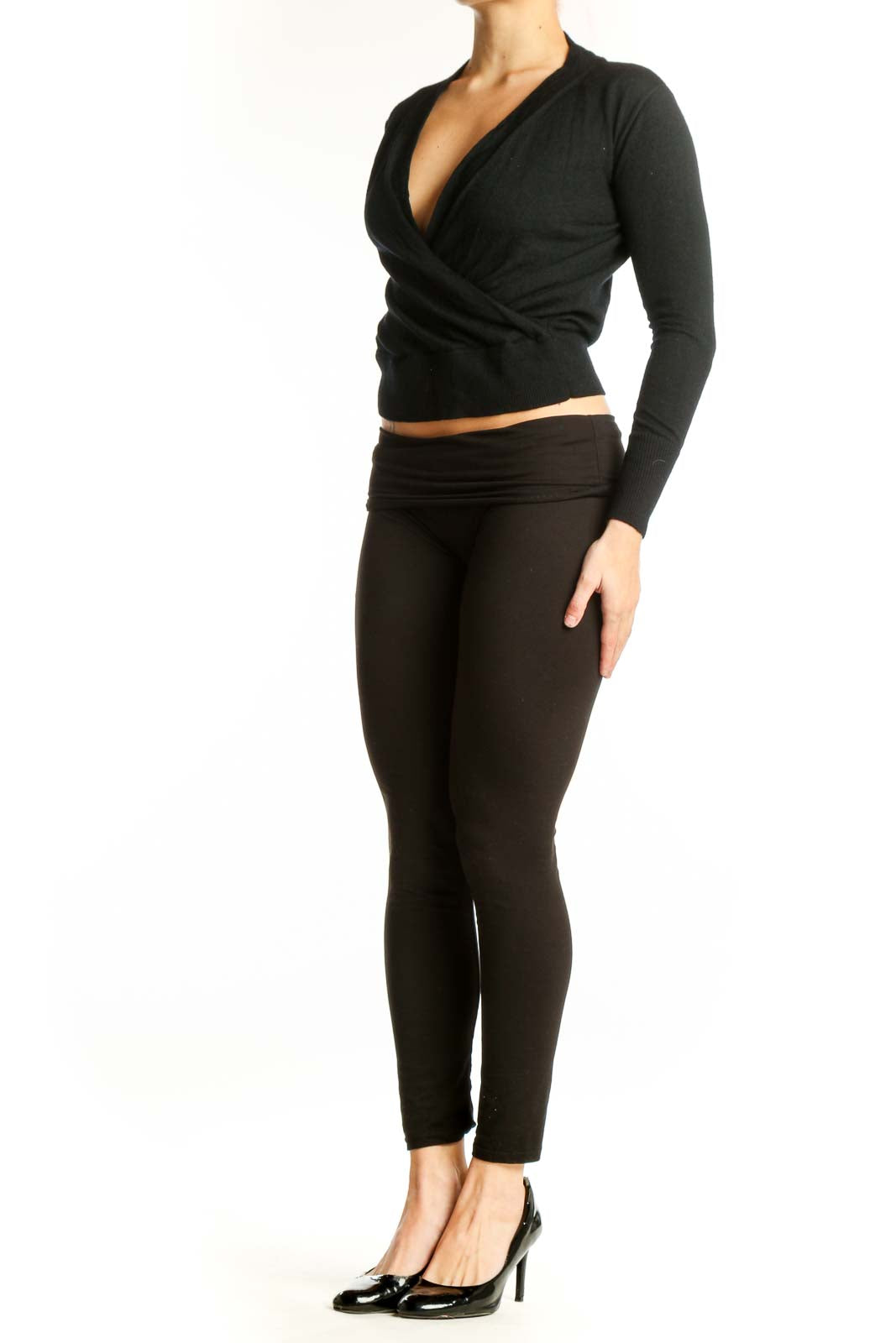 Black Merino Wool wrap crop top with V-neckline and wrap-front design, shown on model from front