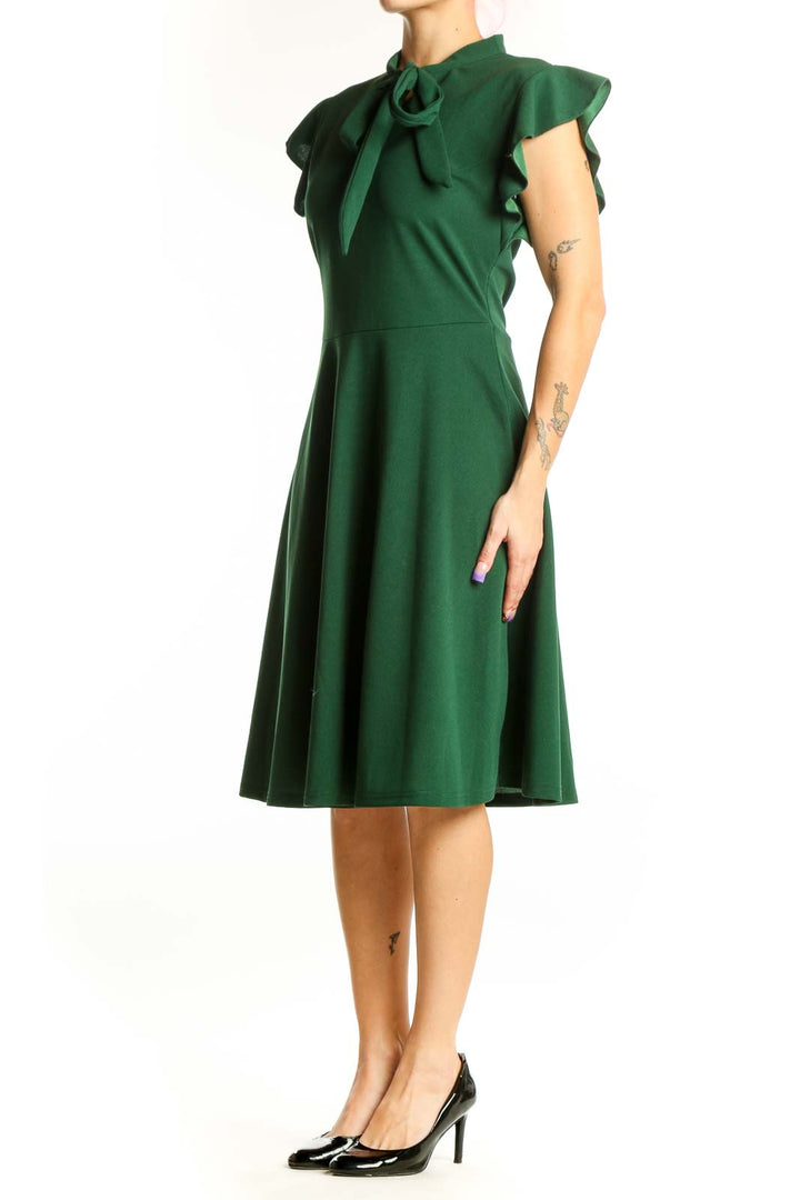 Front view of green tie neck cap sleeve midi dress with A-line skirt