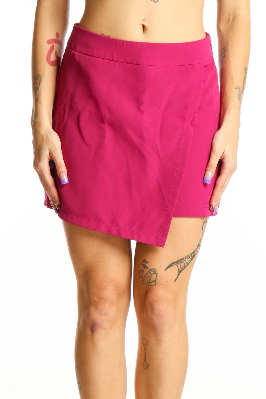 Front view of pink asymmetrical shorts with high-waisted design and stretch fabric