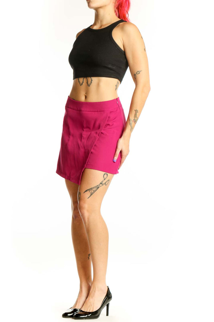 Front view of pink asymmetrical shorts with high-waisted design and stretch fabric