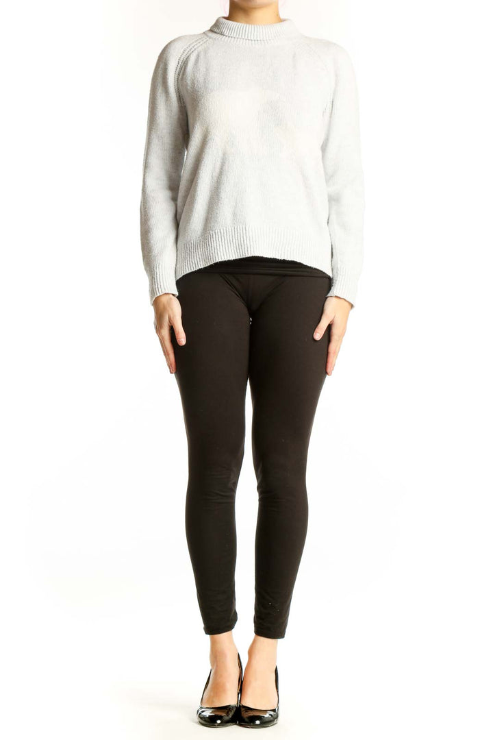 Front view of cream knit pullover sweater with crew neckline and ribbed detailing