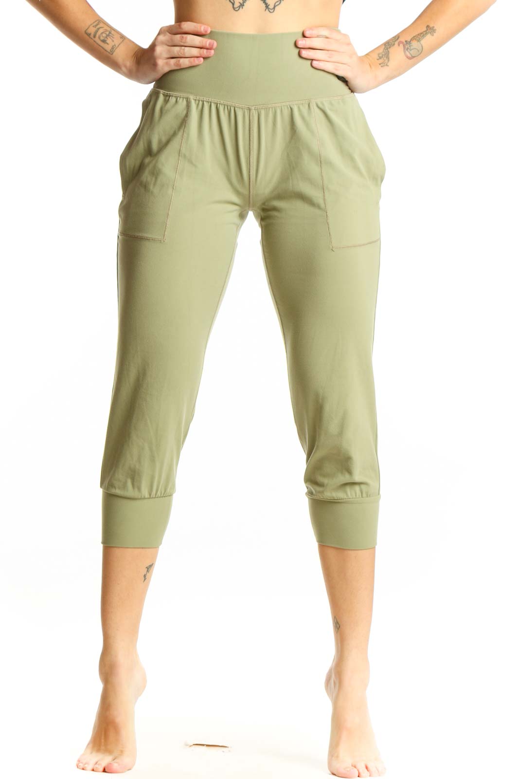 Front view of sage green Athleta capri pants with high waistband and side pockets on model