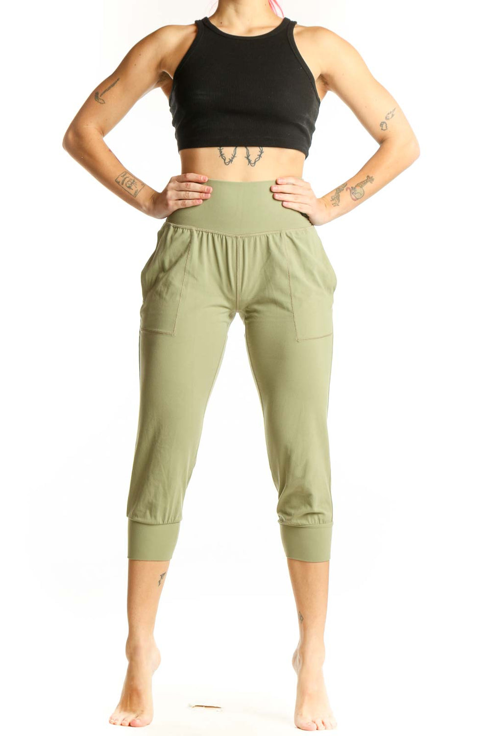 Front view of sage green Athleta capri pants with high waistband and side pockets on model