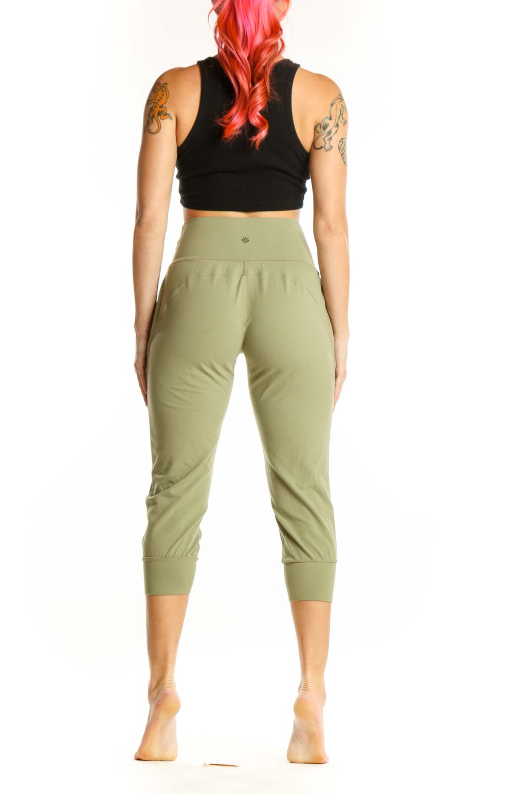 Back view of sage green Athleta capri pants showing gathered hip detail and functional back pockets
