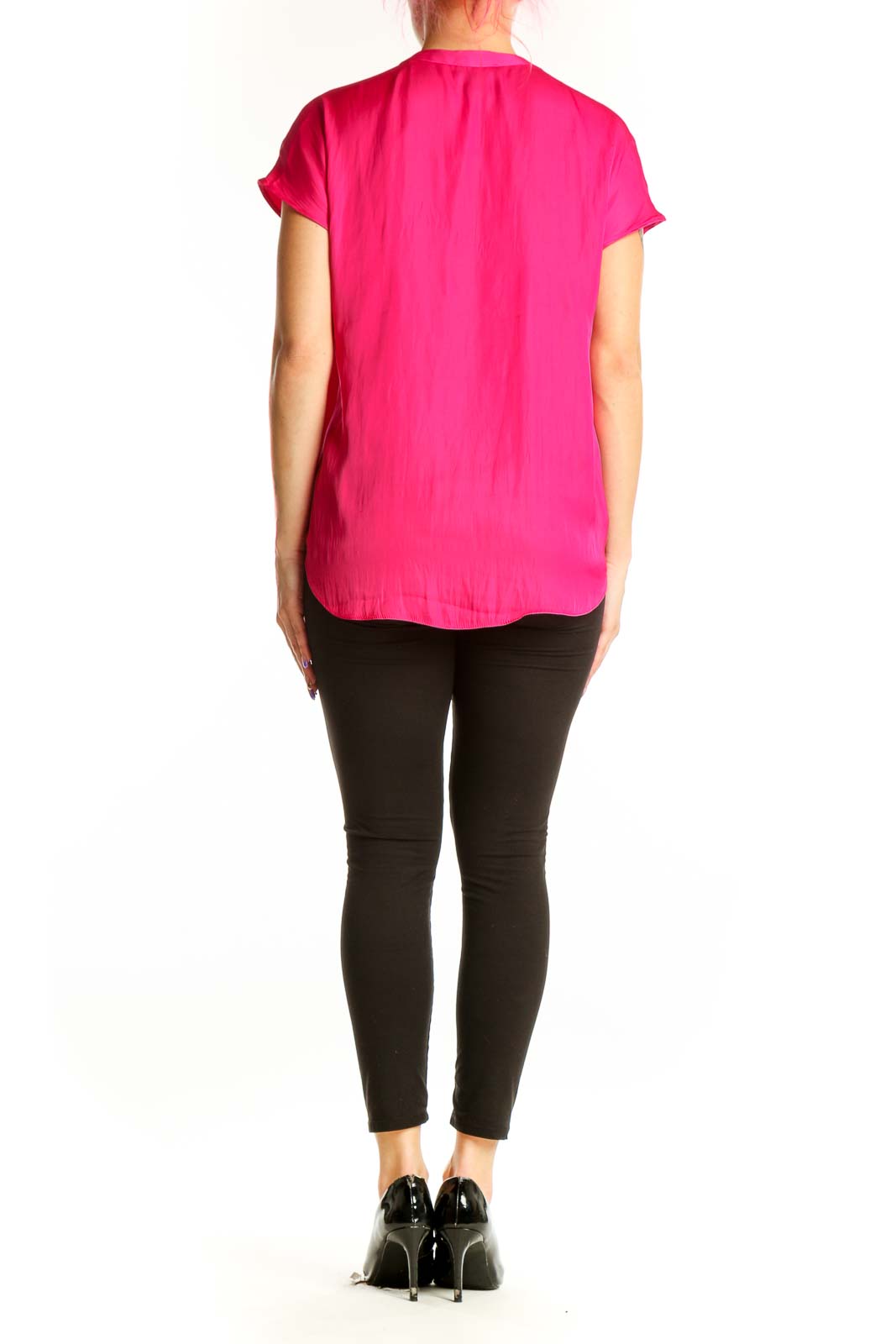 Back view of pink pleated V-neck top showing elegant draping and short sleeve design