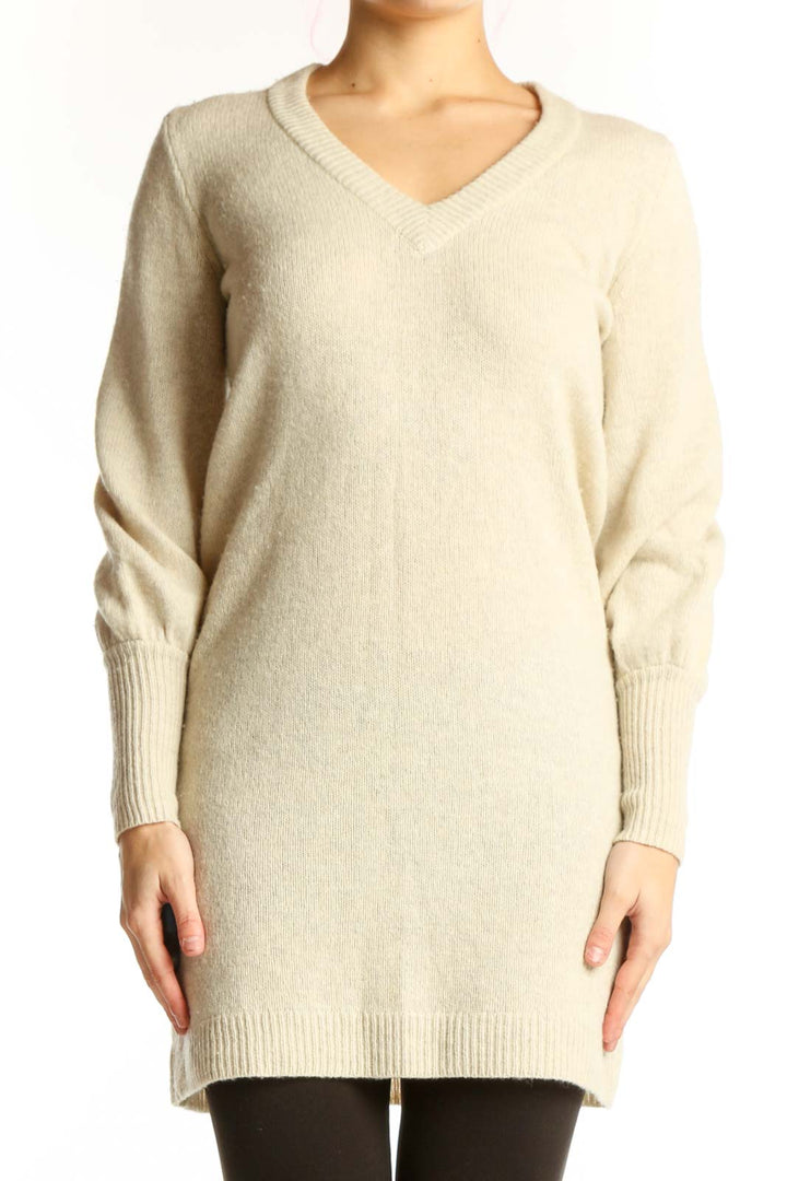 Madewell cream merino wool V-neck sweater dress with long sleeves and ribbed cuffs, front view on model