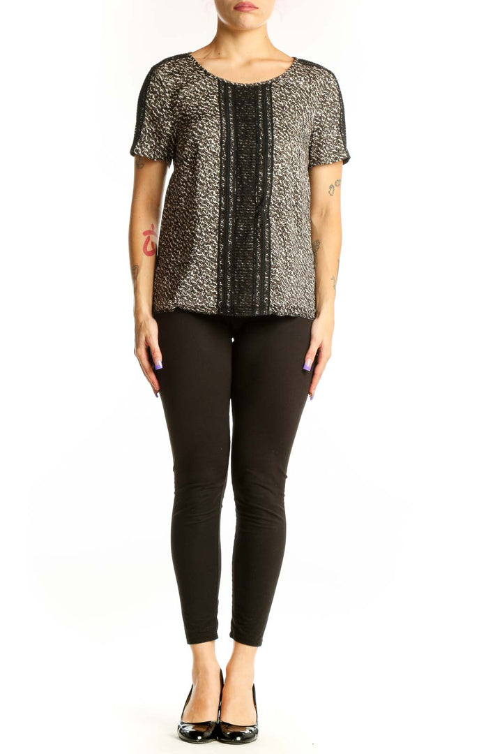 Ann Taylor black metallic short-sleeve top with gold threading and textured center panel, front view