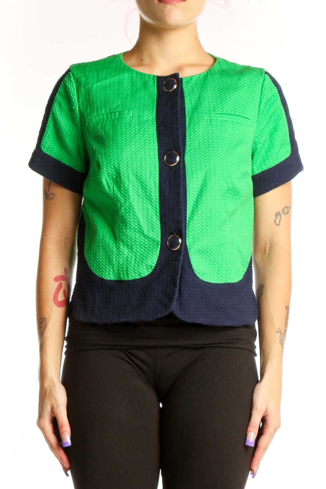 Front view of green and navy color-block quilted short-sleeve jacket by Laundry with button-front closure