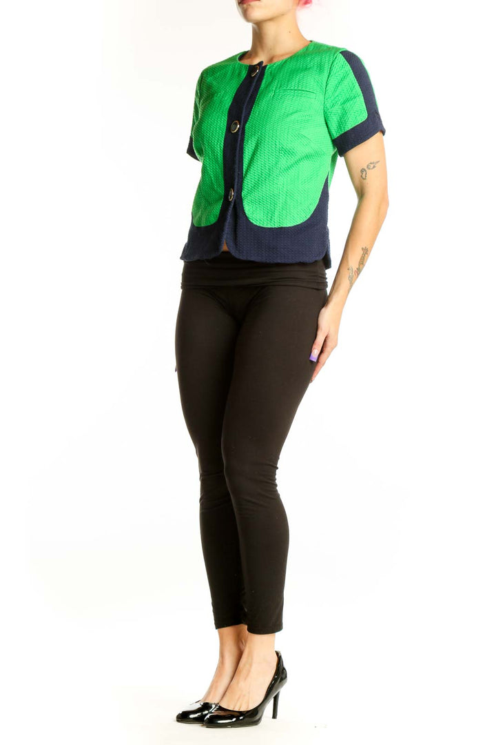 Front view of green and navy color-block quilted short-sleeve jacket by Laundry with button-front closure