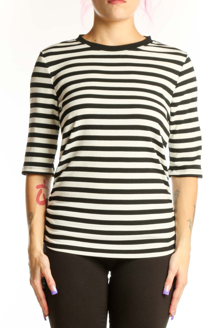 Black and white horizontally striped three-quarter sleeve top by Sanctuary, front view on model