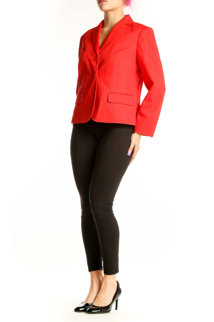 Red classic blazer jacket with notch lapel and three-button front, worn with black pants