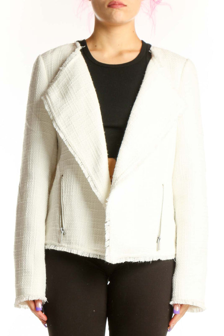 Cream textured blazer with notch lapels and frayed hem worn over black top, front view
