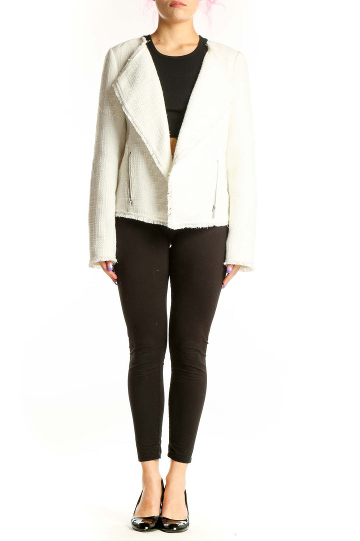 Cream textured blazer with notch lapels and frayed hem worn over black top, front view
