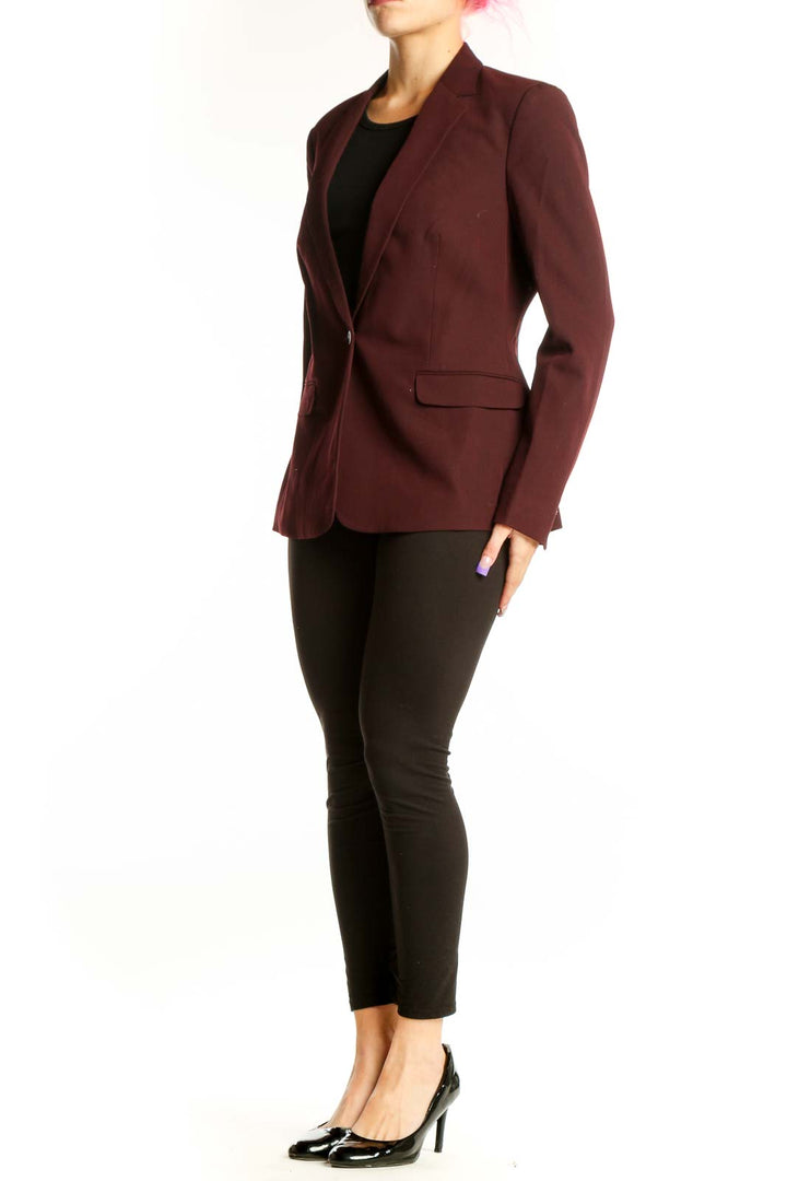 Burgundy single-button tailored blazer by Tahari worn with black top, front view