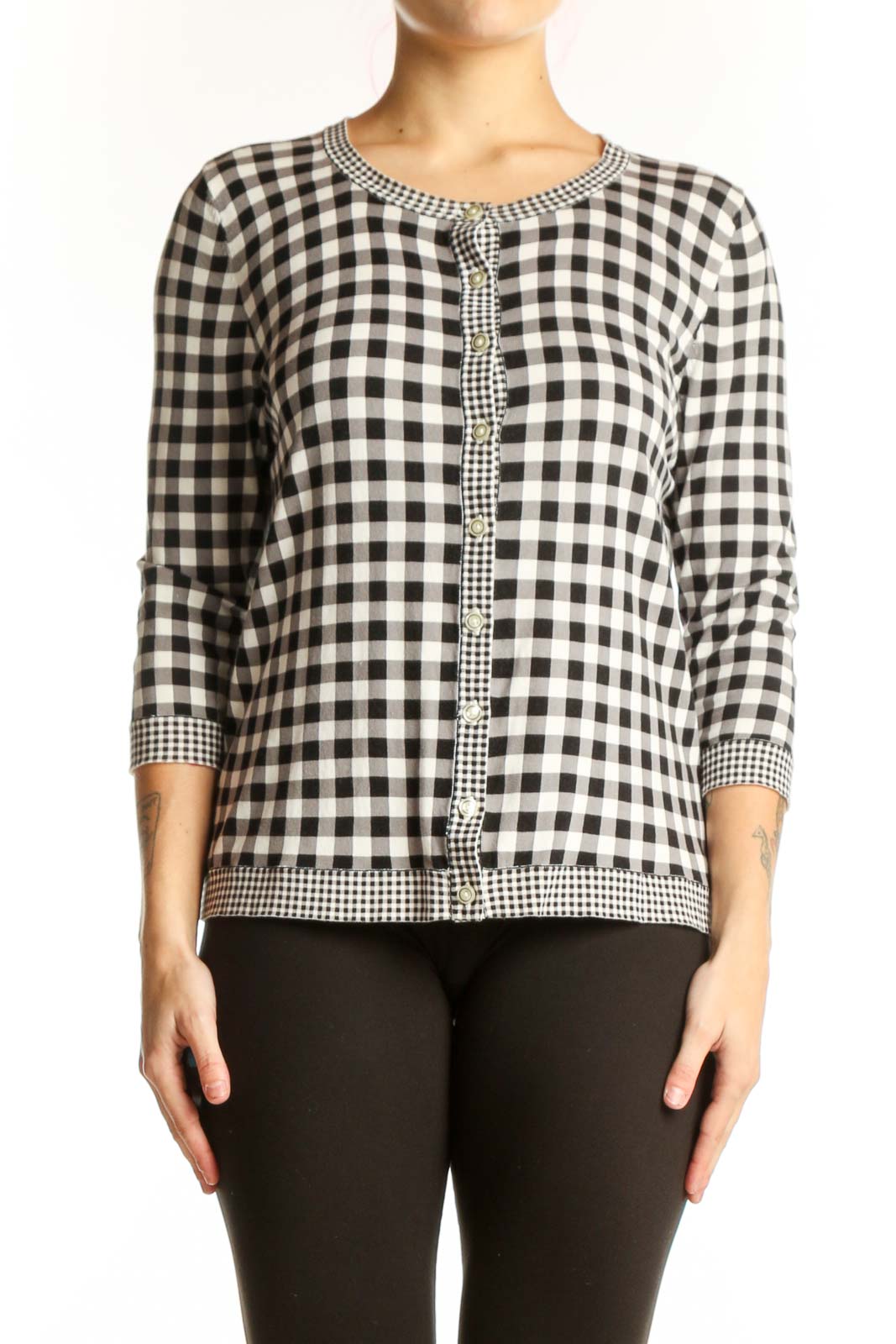 Black and white gingham knit cardigan with beaded trim and button-front closure, worn with black pants