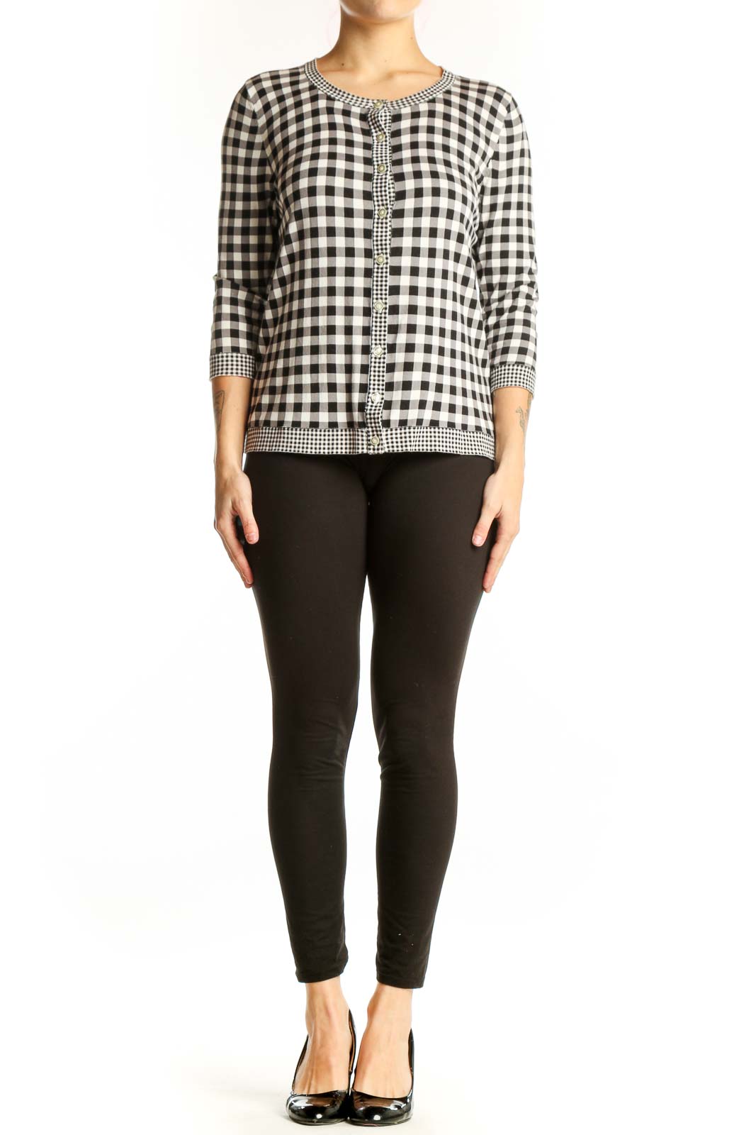 Black and white gingham knit cardigan with beaded trim and button-front closure, worn with black pants