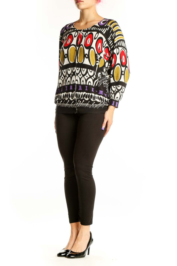 Front view of multicolor abstract geometric knit sweater by JOSEPH A. with vibrant red, gold, purple, and black interlocking circular patterns