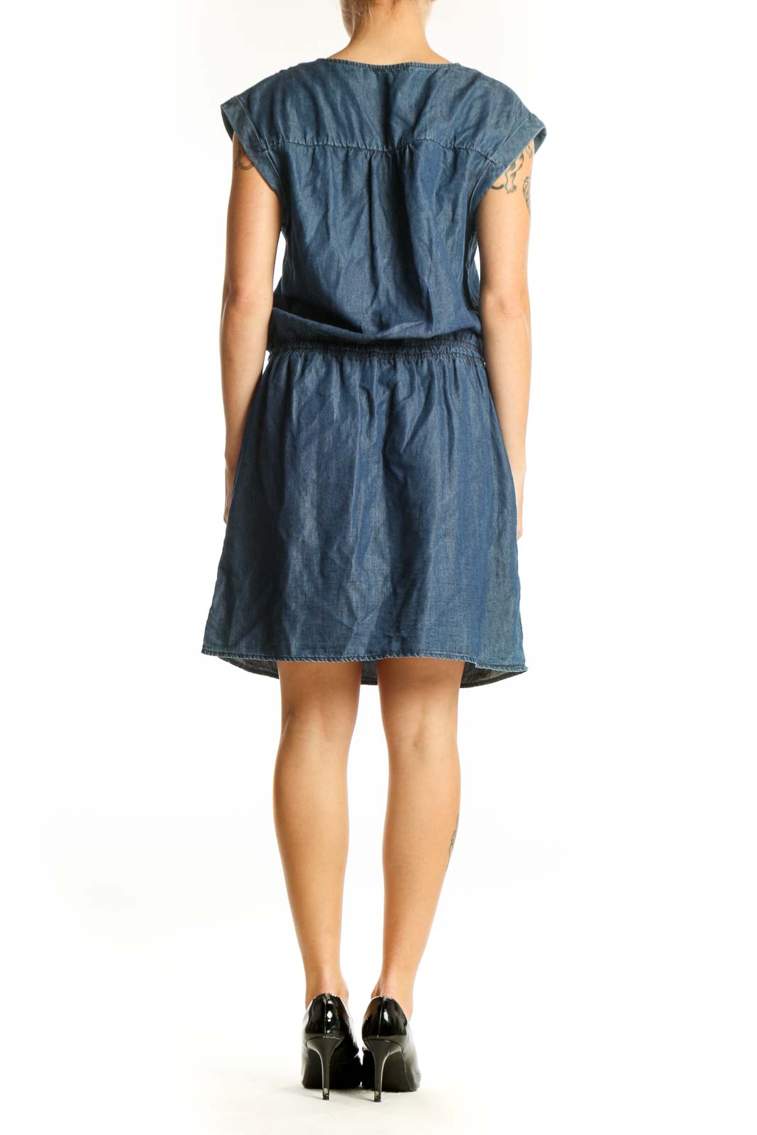 Side view of Promod blue denim dress showing relaxed silhouette and knee-length cut