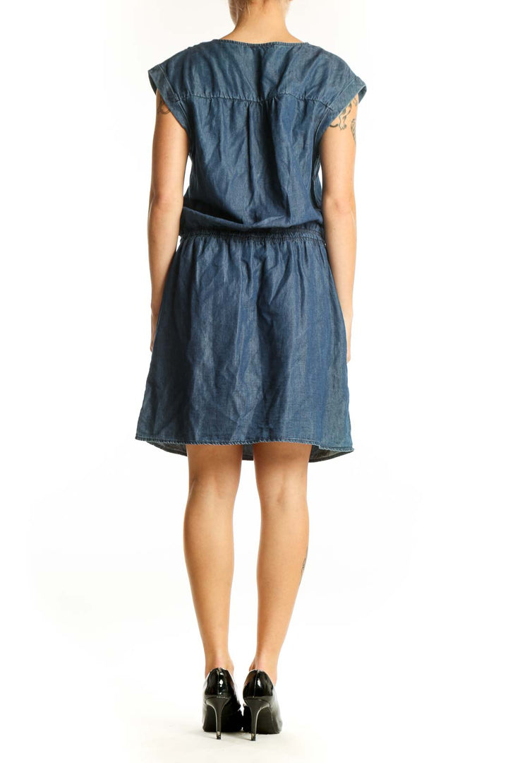 Side view of Promod blue denim dress showing relaxed silhouette and knee-length cut