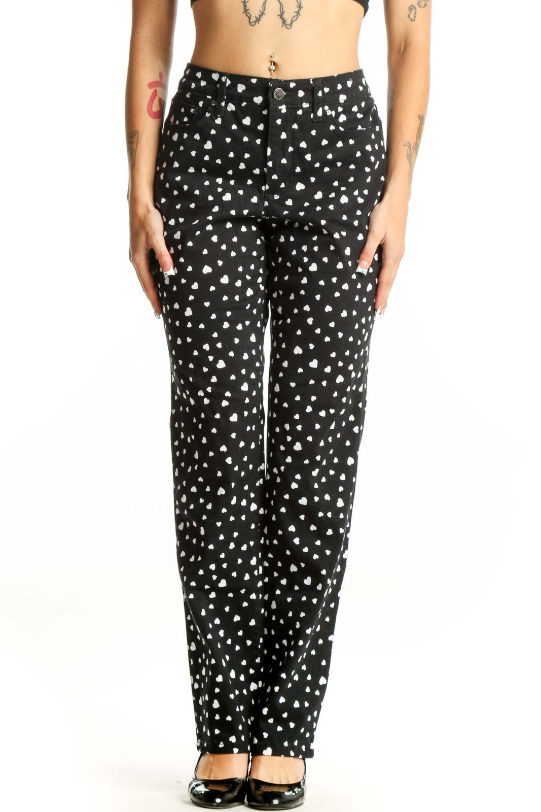 Front view of black straight-leg pants with white heart pattern