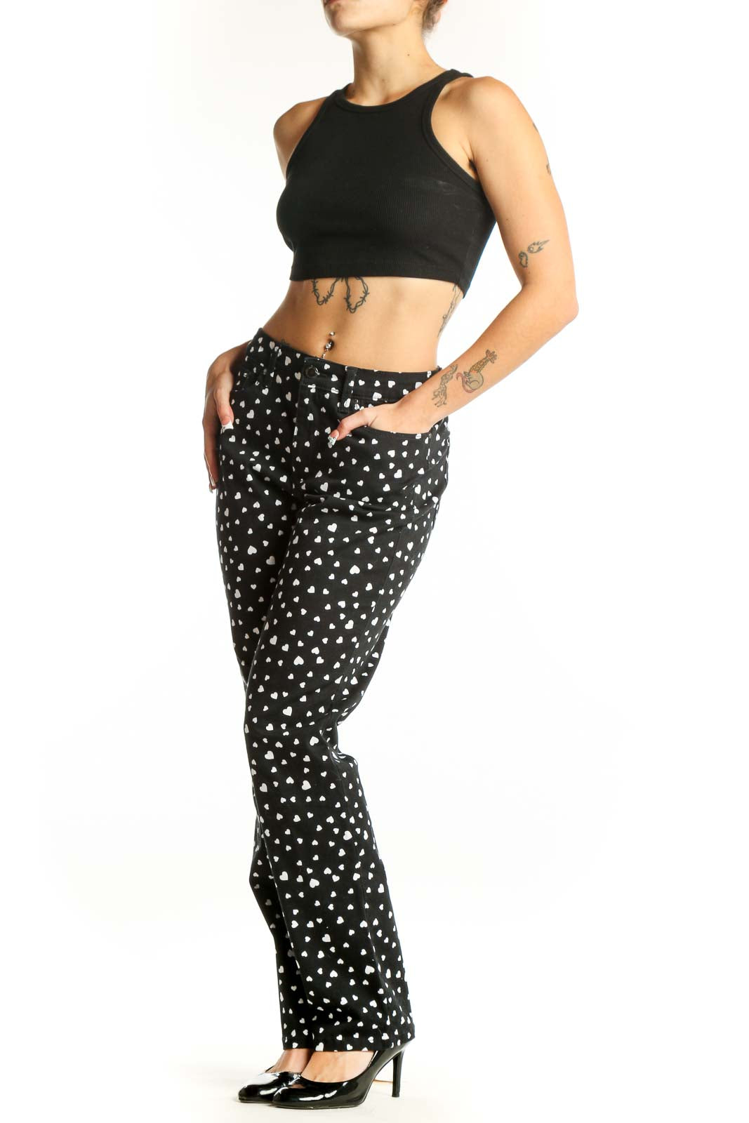 Front view of black straight-leg pants with white heart pattern