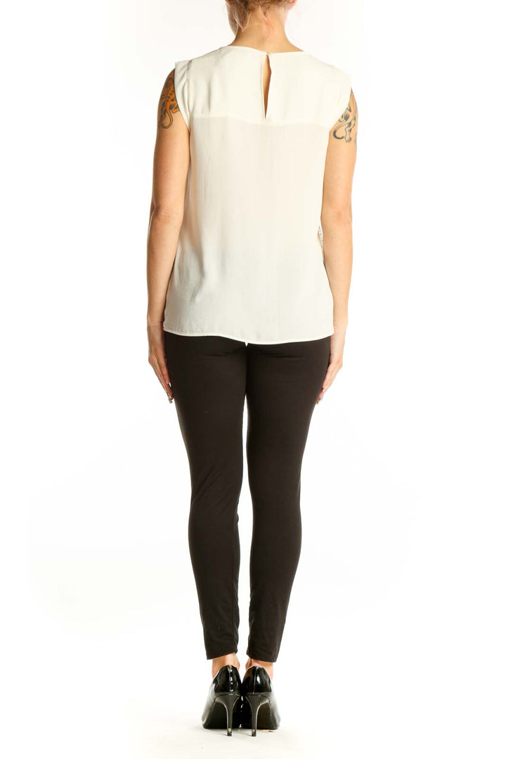 Side view of white lace overlay sleeveless blouse from LOFT on model