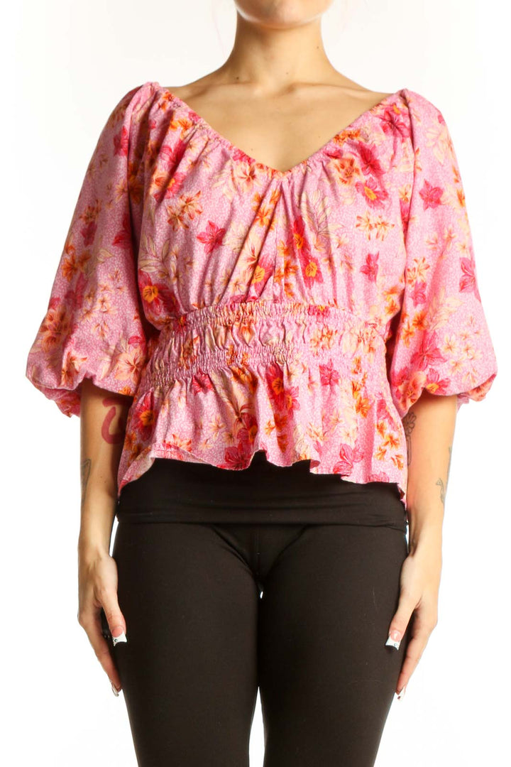 Front view of pink floral puff sleeve peplum top from LOFT