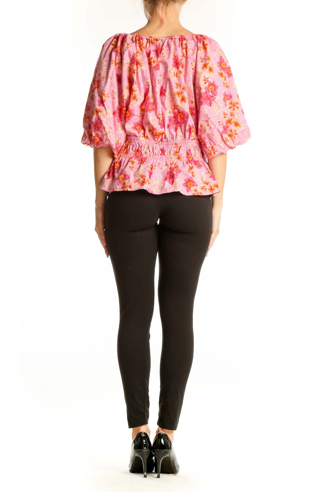 Side view of pink floral puff sleeve peplum top from LOFT on model