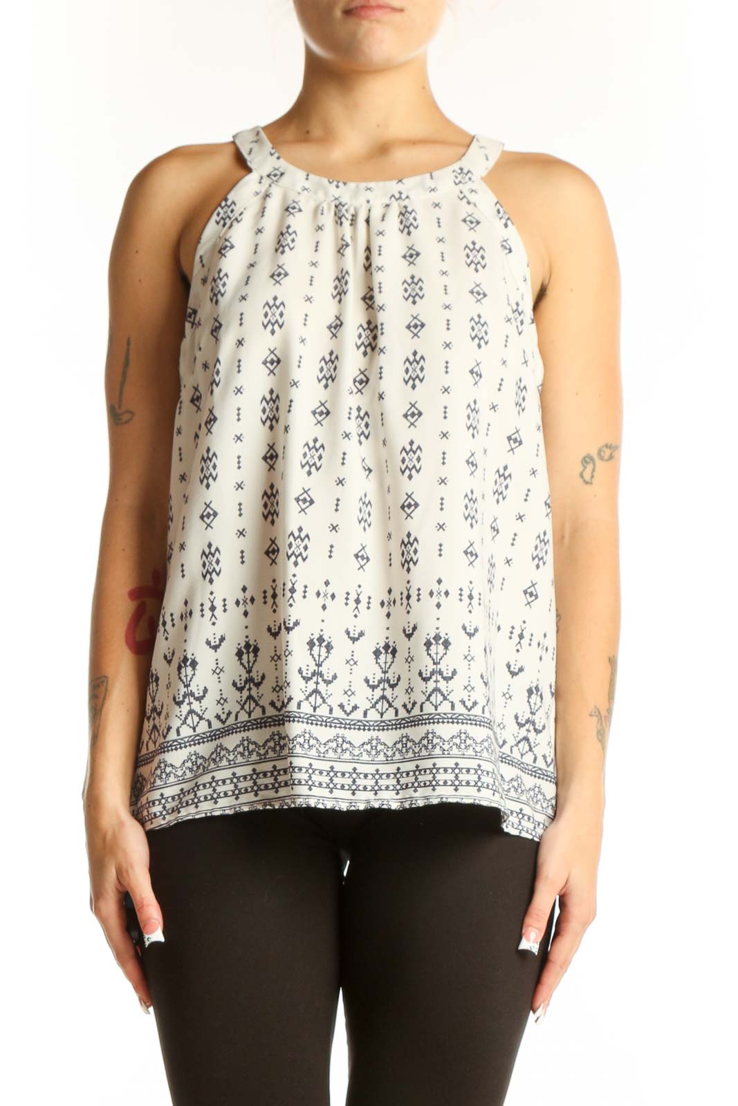 Front view of white sleeveless blouse with navy floral print by Skies Are Blue