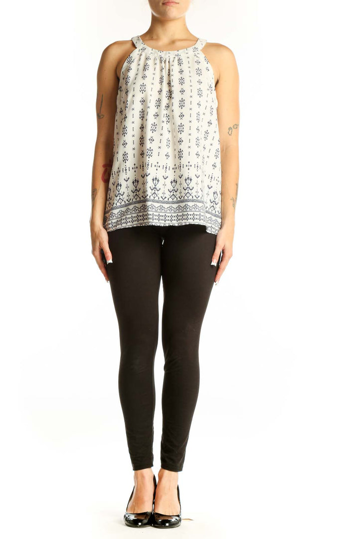 Front view of white sleeveless blouse with navy floral print by Skies Are Blue