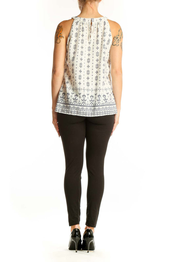 Side view of white sleeveless blouse with navy floral print by Skies Are Blue