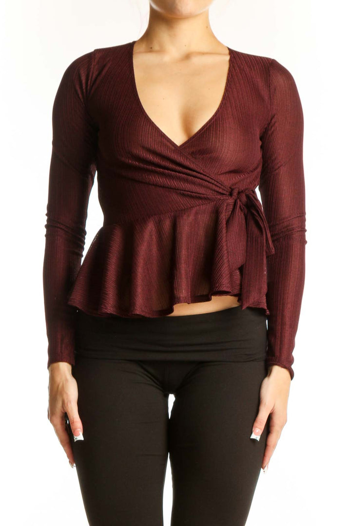 Front view of burgundy wrap peplum top with V-neckline and side tie