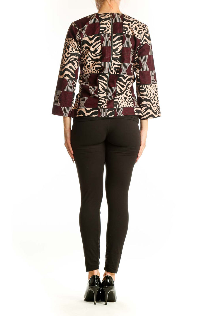 Back view of Heritage Clothing burgundy animal print patchwork top with black pants