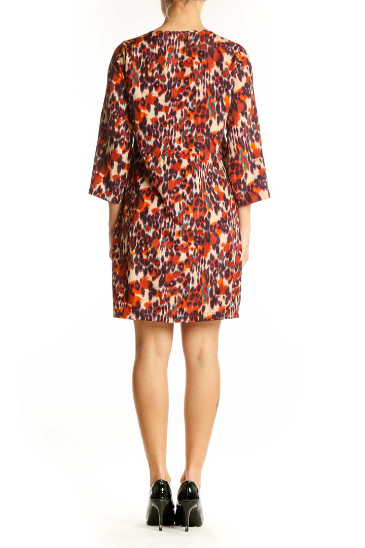 Side view of orange leopard print shift dress by bar III