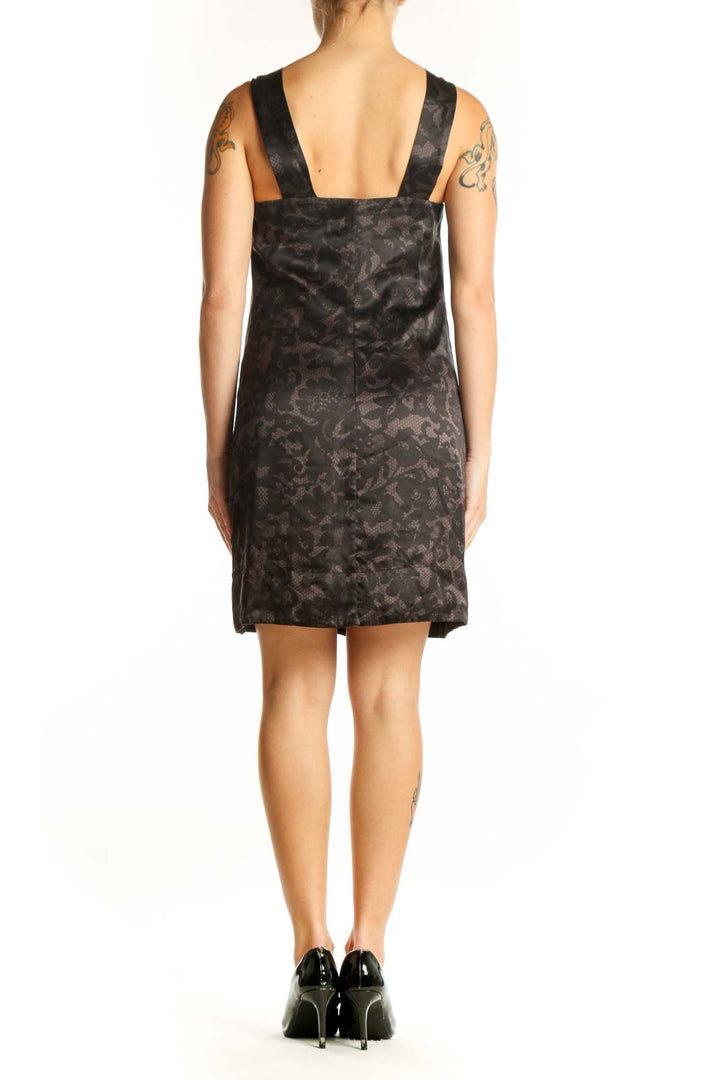 Side view of Banana Republic black floral cocktail dress showing flowing silhouette