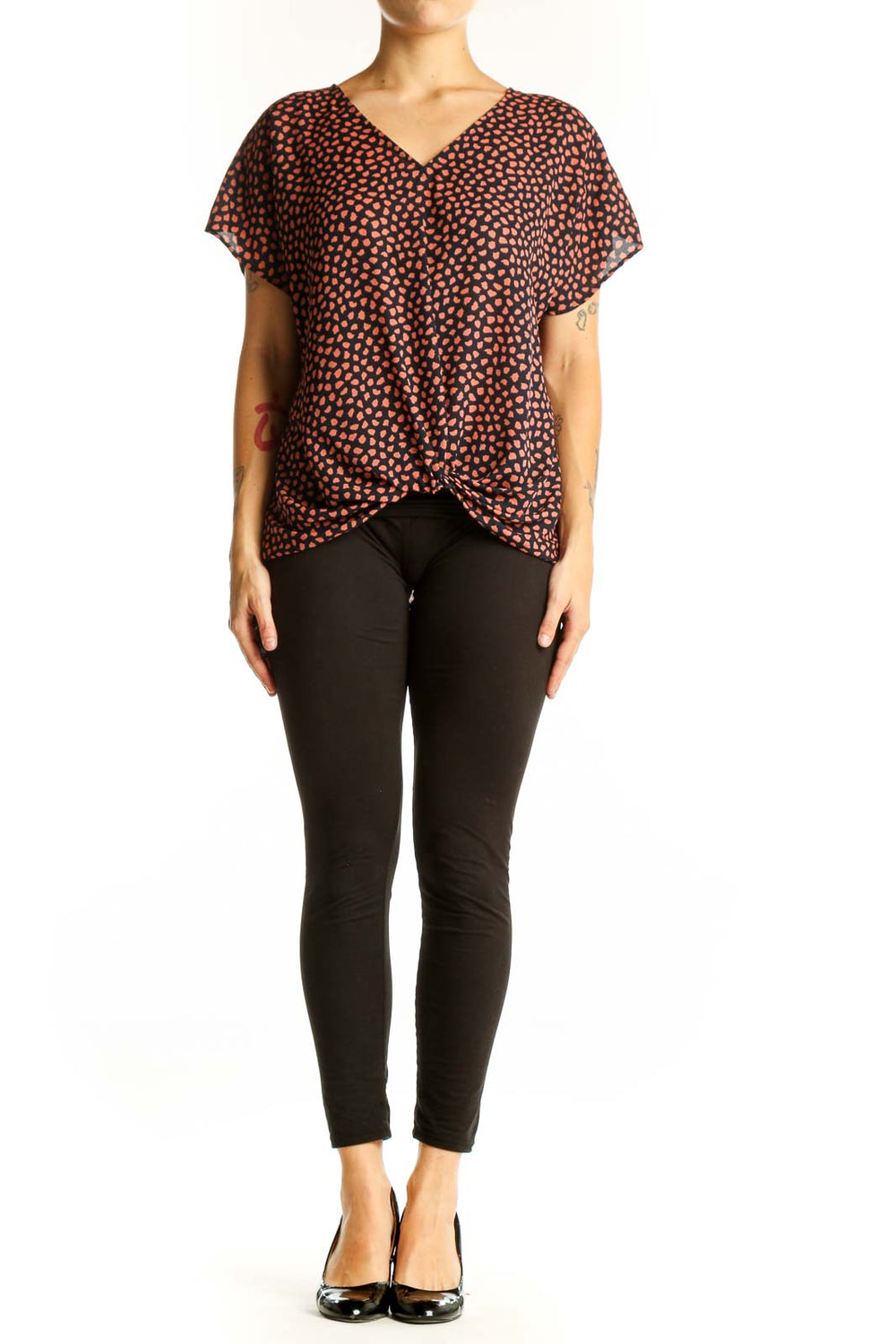 Front view of West Kei Black and Coral Spotted V-Neck Blouse with twist-front hem