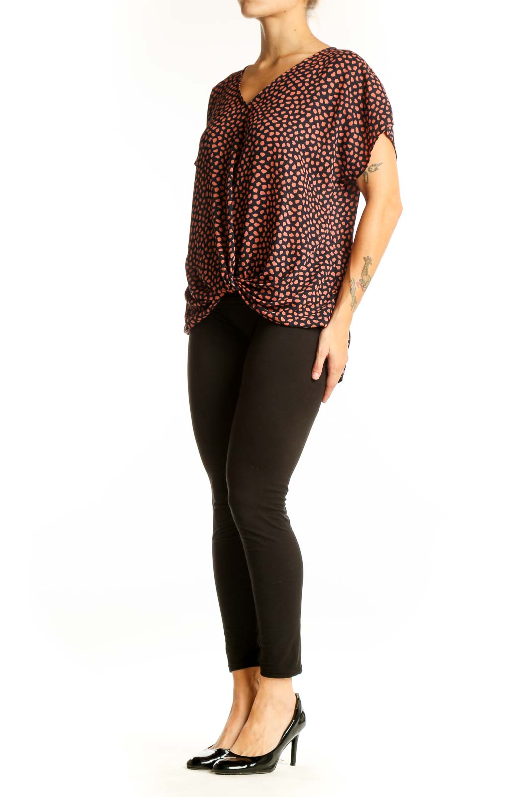 Front view of West Kei Black and Coral Spotted V-Neck Blouse with twist-front hem