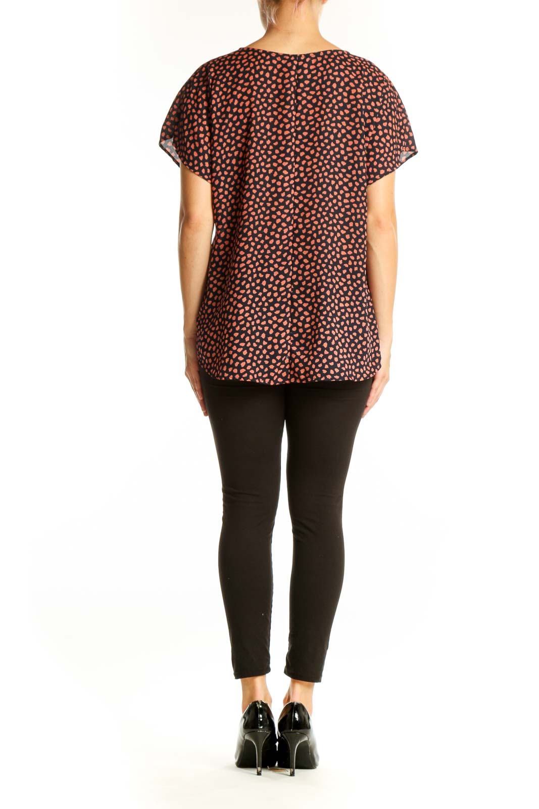 Side view of West Kei Black and Coral Spotted V-Neck Blouse showing drape and fit