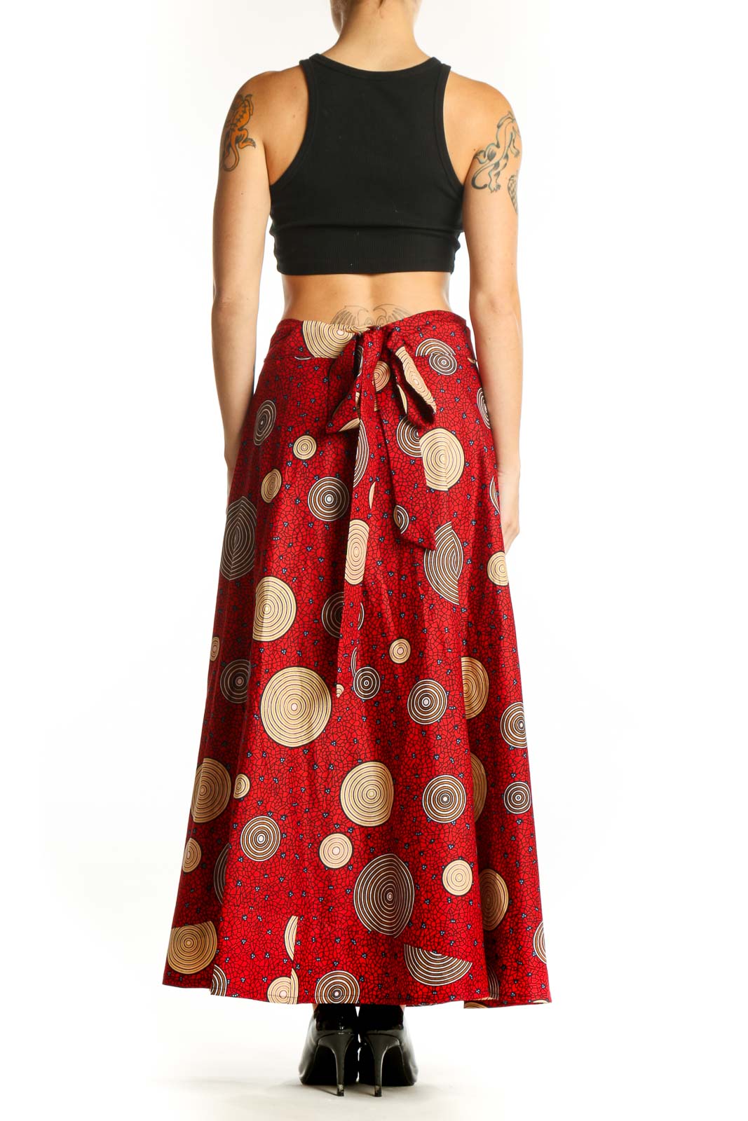 Side view of red maxi skirt with circular patterns on model