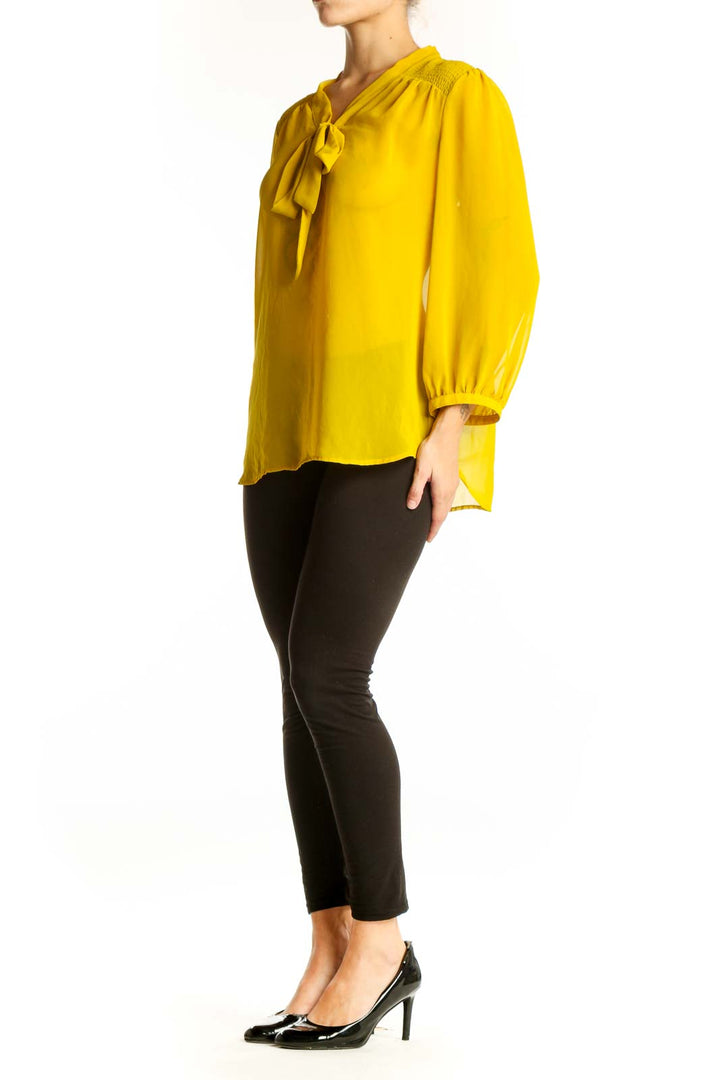 Front view of yellow sheer tie-neck blouse from LOFT