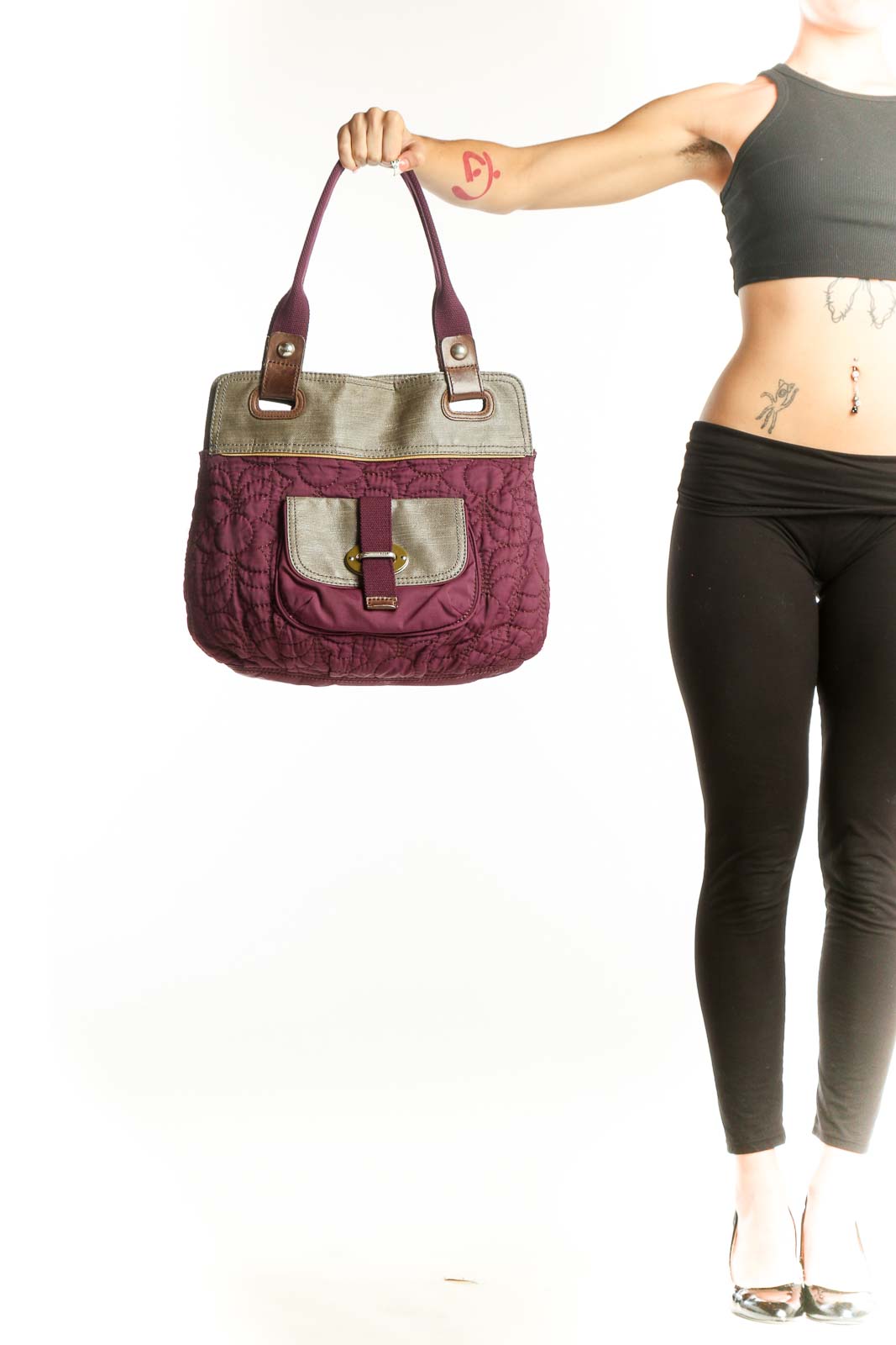 Front view of purple quilted Fossil messenger bag with beige trim