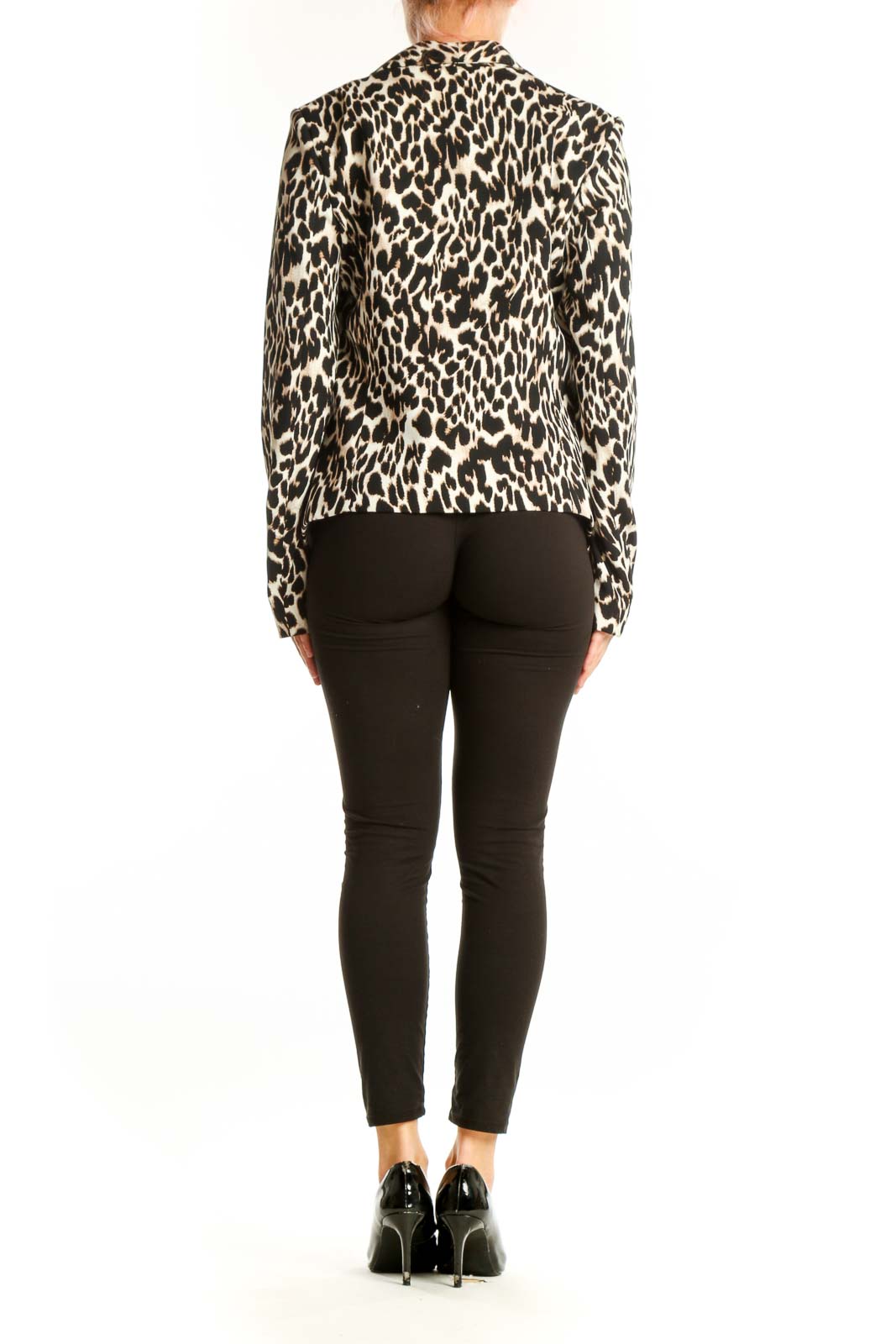 Side view of model wearing Calvin Klein leopard print jacket with black pants