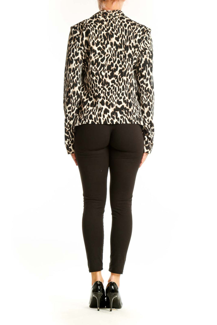 Side view of model wearing Calvin Klein leopard print jacket with black pants