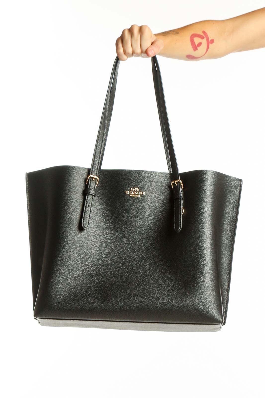 Front view of black leather Coach tote bag with gold hardware