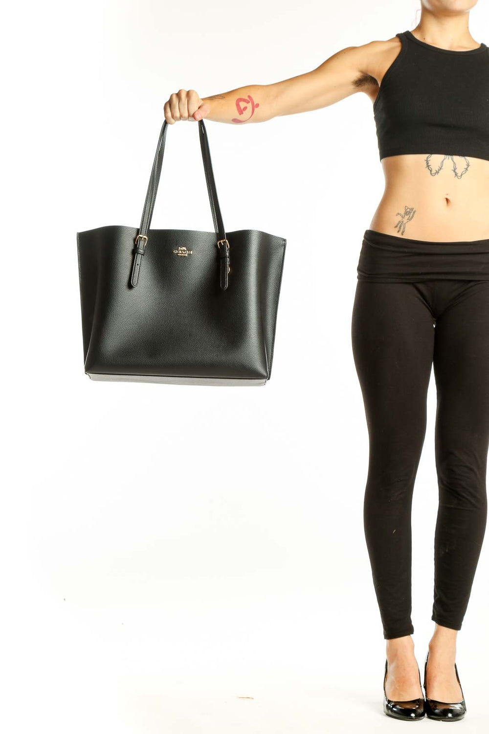 Front view of black leather Coach tote bag with gold hardware