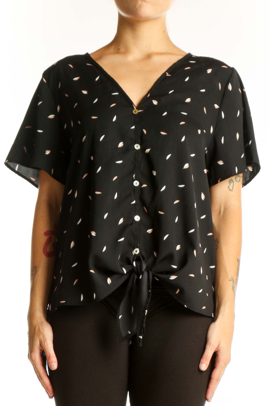 Front view of West Kei black blouse with white leaf pattern and tie-front detail