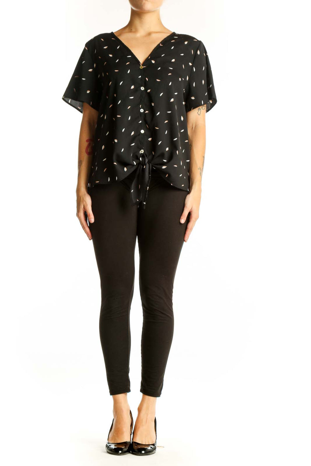 Front view of West Kei black blouse with white leaf pattern and tie-front detail