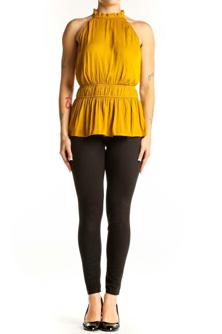 Front view of Nine West mustard sleeveless top with ruffled neckline and peplum waist