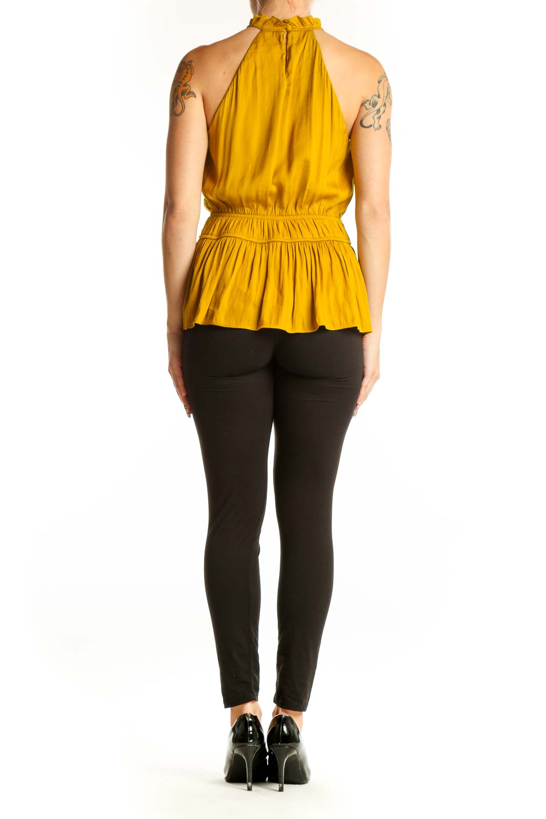 Side view of Nine West mustard sleeveless top showing peplum silhouette