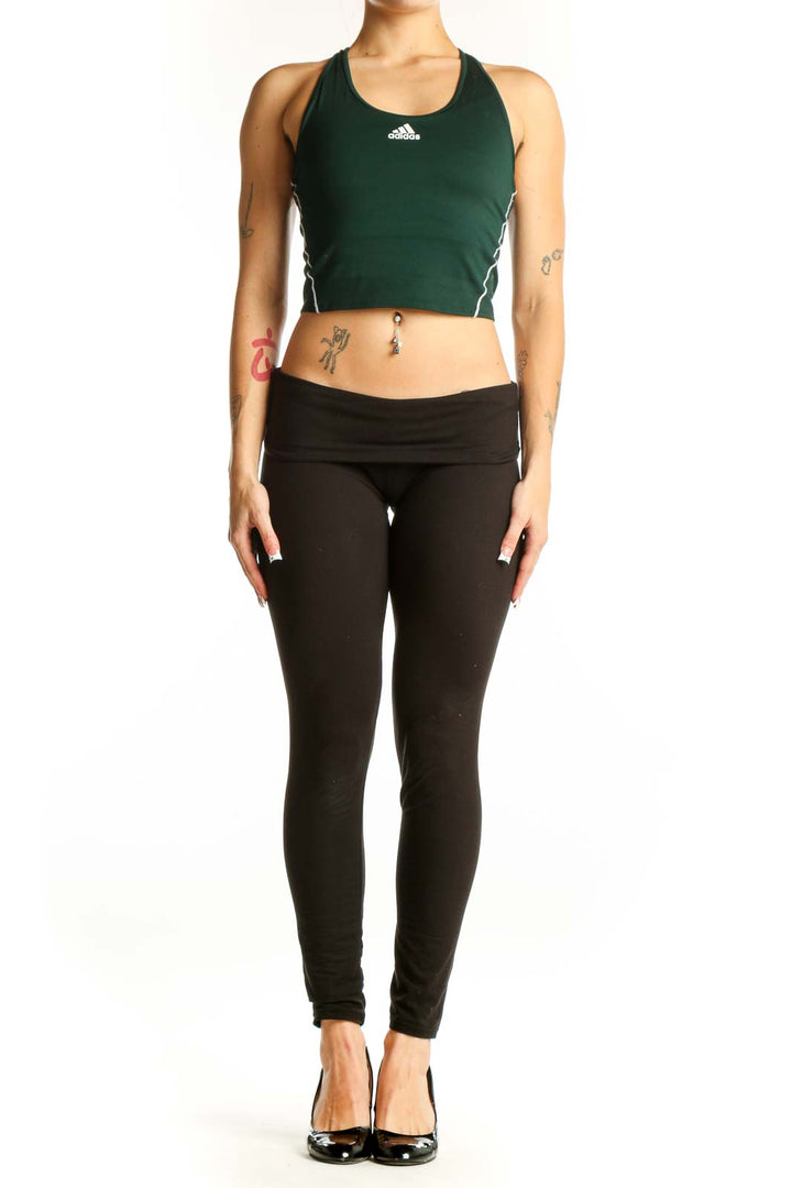 Front view of green Adidas racerback crop top on model